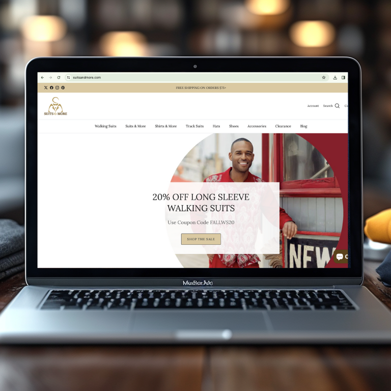 a laptop on a table, showing the suits & more website.