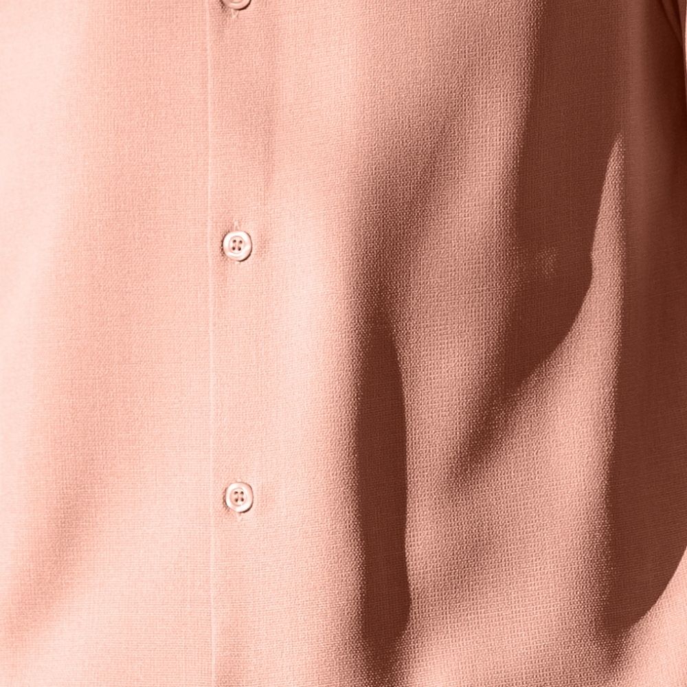 Blush textured linen-look fabric detail on a men's walking suit shirt showing the button and pocket.