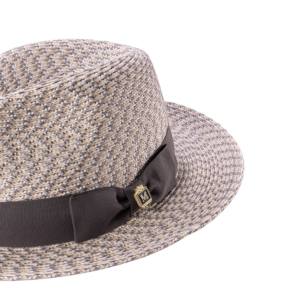 Close-up grosgrain ribbon and crest pin detail on fedora hat