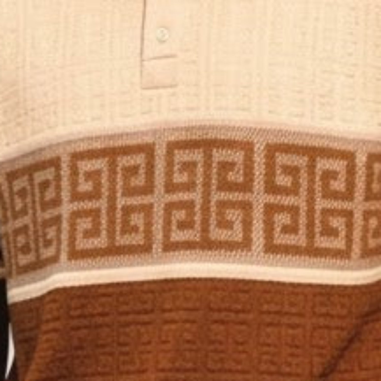 close-up of tan knit polo shirt with greek key border pattern