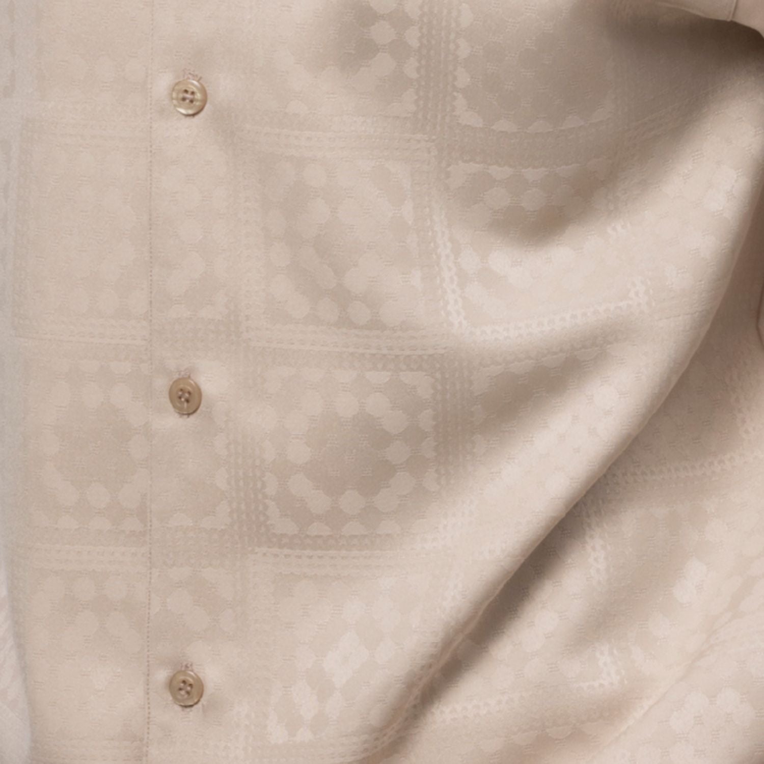 Close up of the beige tonal check walking suit with short sleeve shirt and matching pants
