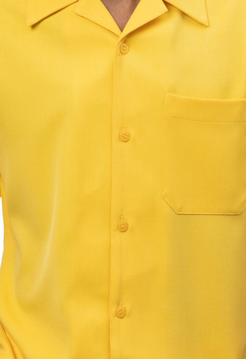 Close-up of canary 100% polyester fabric showing the solid texture and button detail