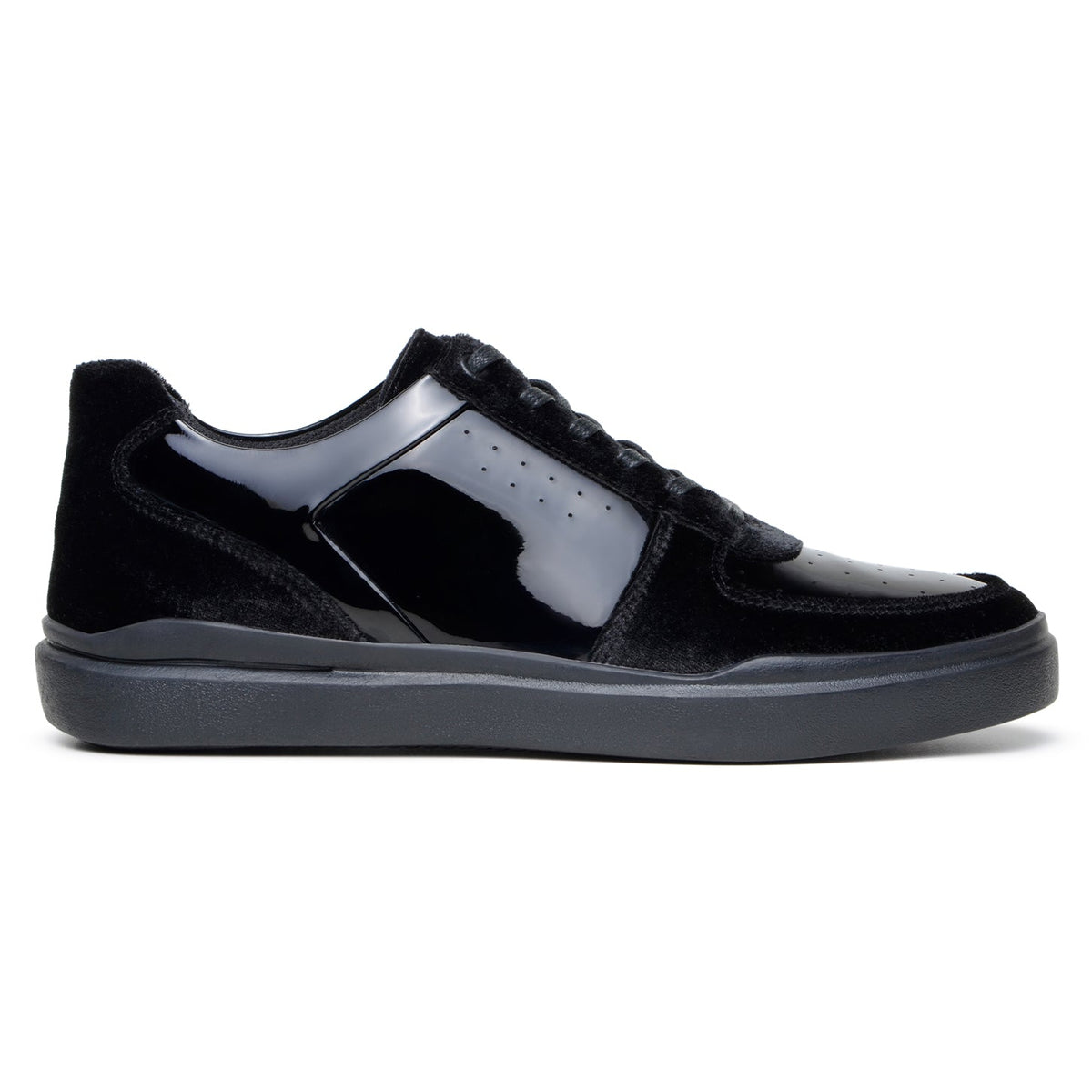 Side profile of black velvet and patent leather court sneaker