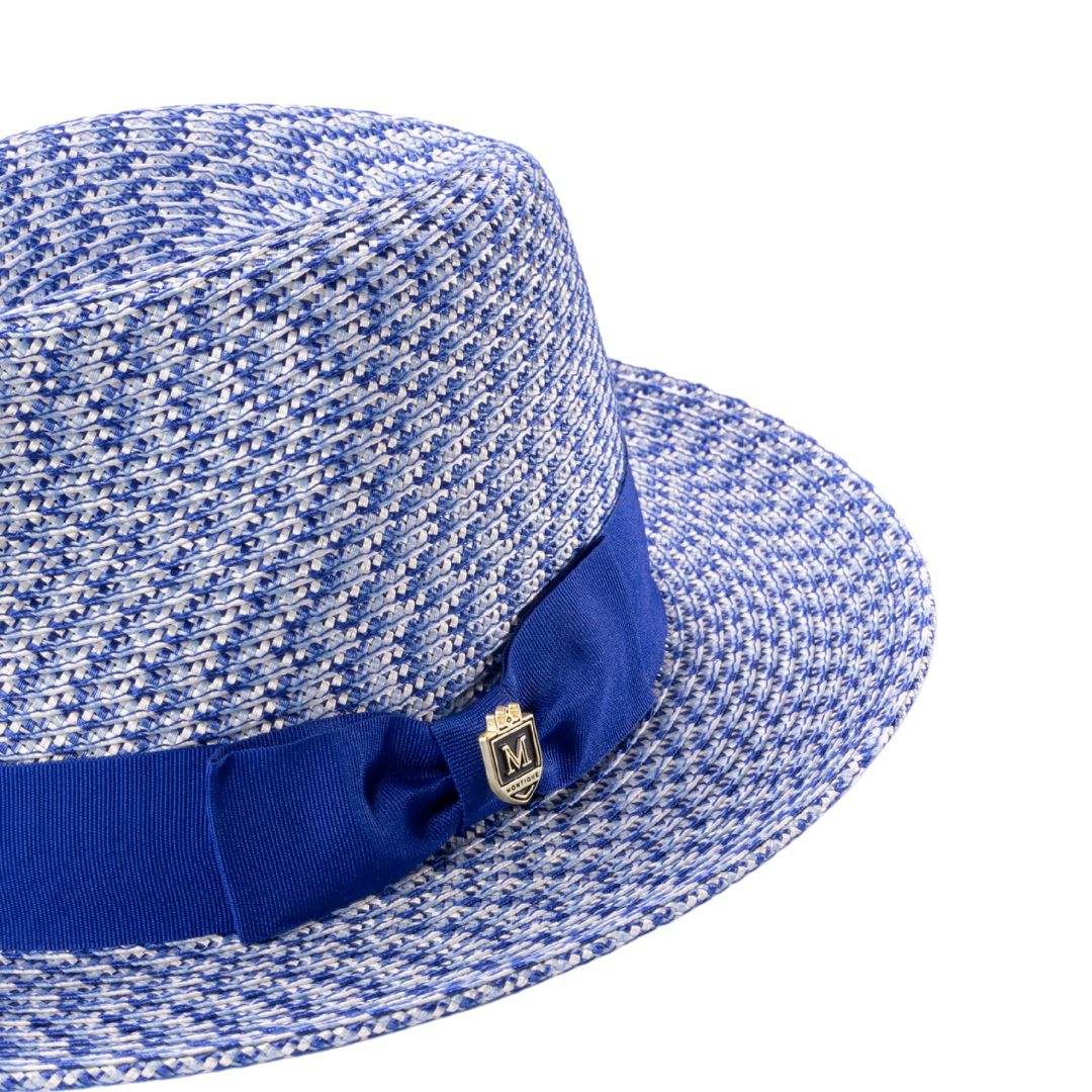 Close-up grosgrain ribbon and crest pin detail on fedora hat
