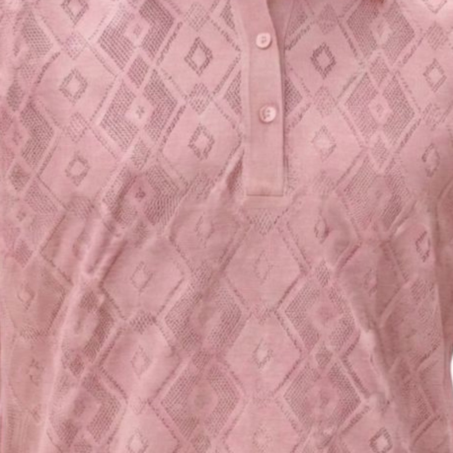 Close-up of the pink textured knit fabric highlighting the diamond motif and buttons