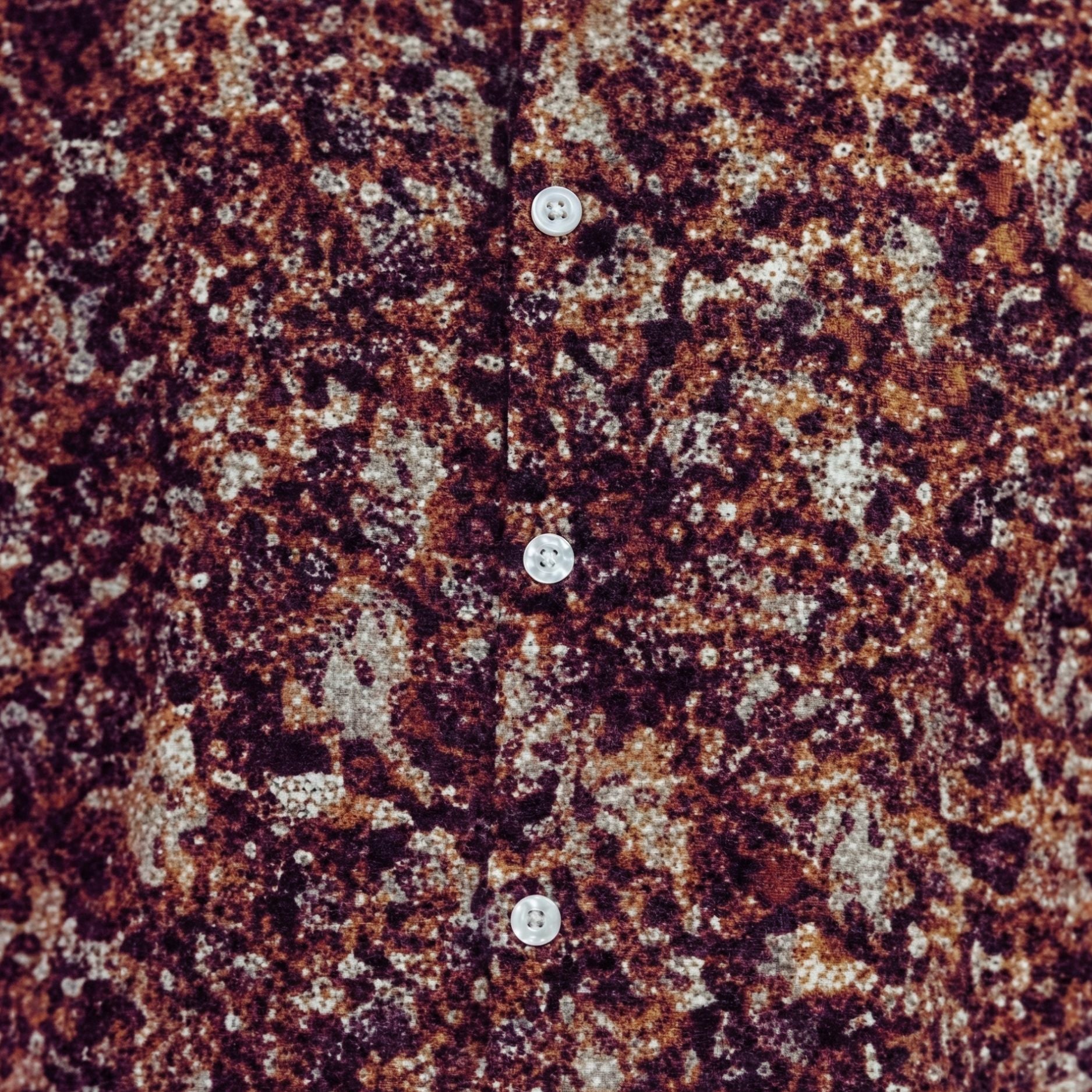 Close-up of the brown shirt showing the abstract print and textured linen blend fabric.