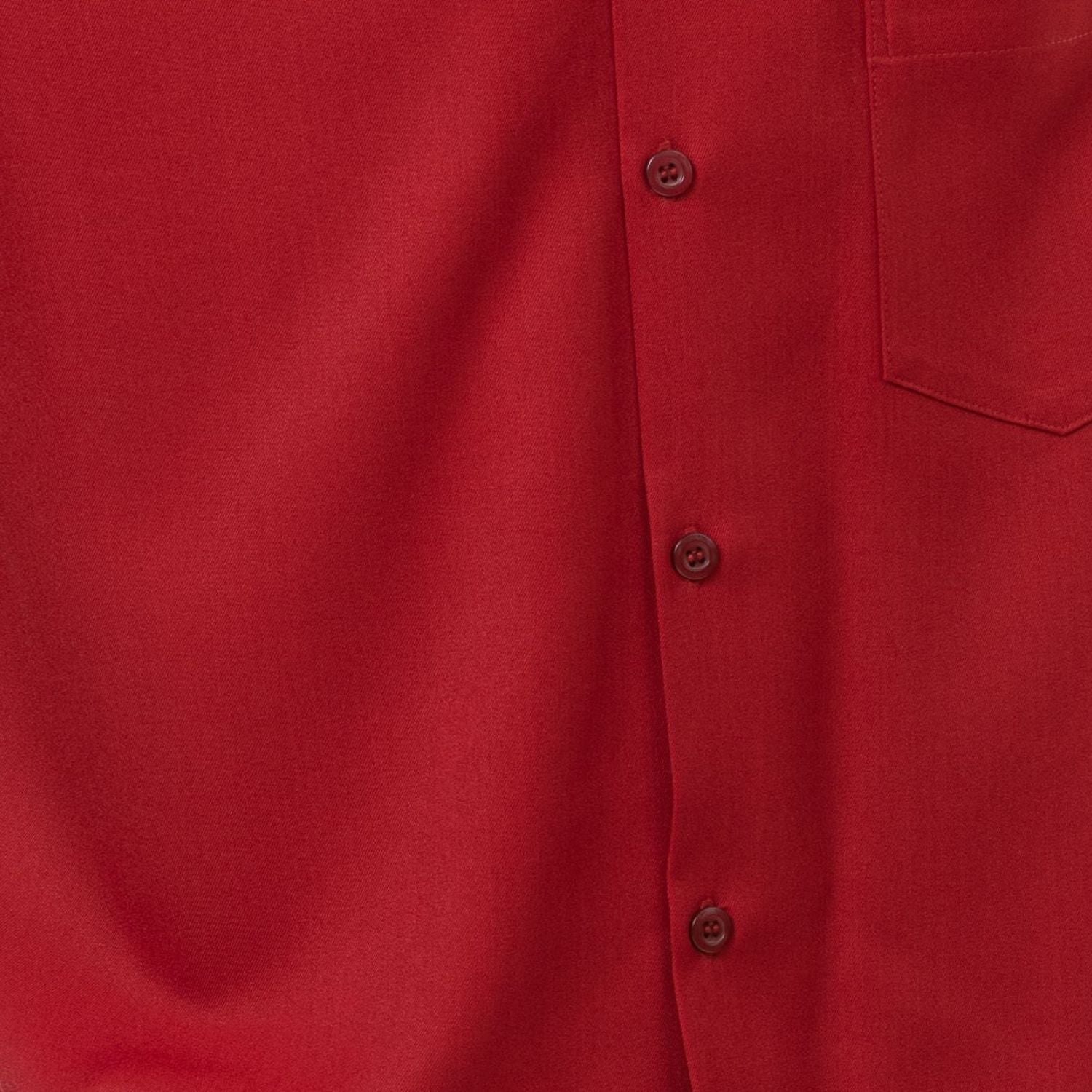 Close-up of cranberry 100% polyester fabric showing the solid texture and button detail