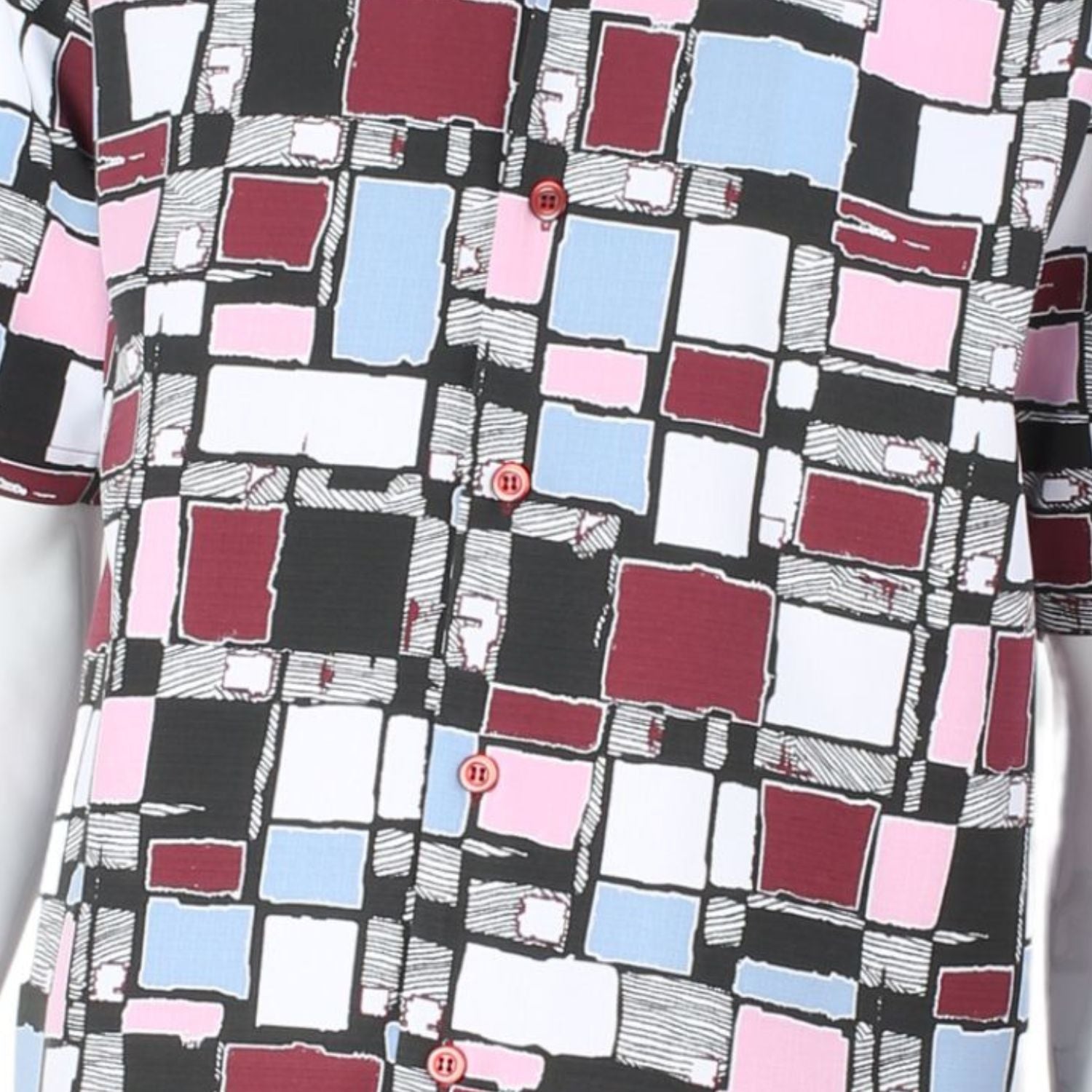 Close up of mosaic square pattern shirt in burgundy, mustard, orange, and white
