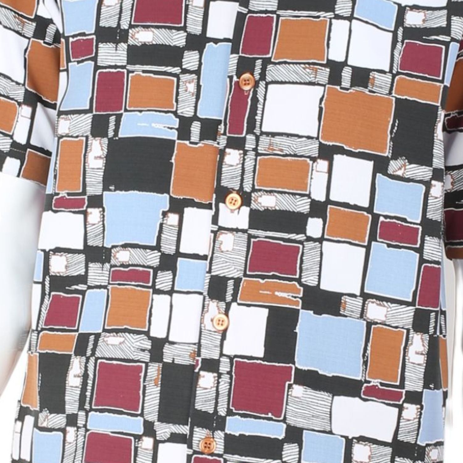Close up of mosaic square pattern shirt in brown, mustard, orange, and white