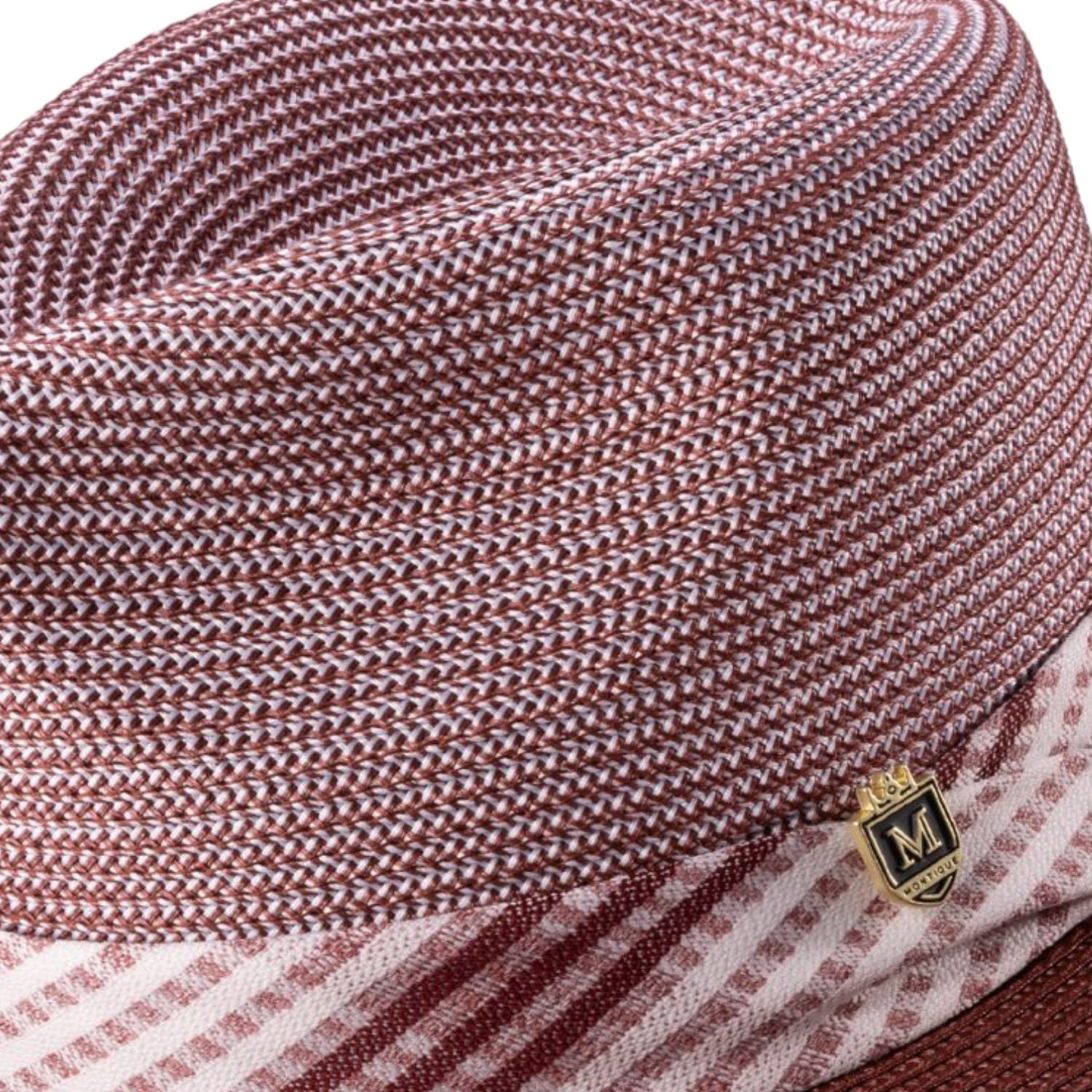 Side view of burgundy fedora hat with striped ribbon band and pin