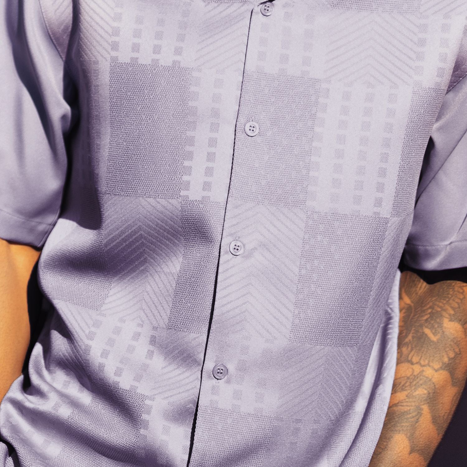 Close-up of lilac walking suit shirt showing the detailed tonal jacquard patchwork pattern.