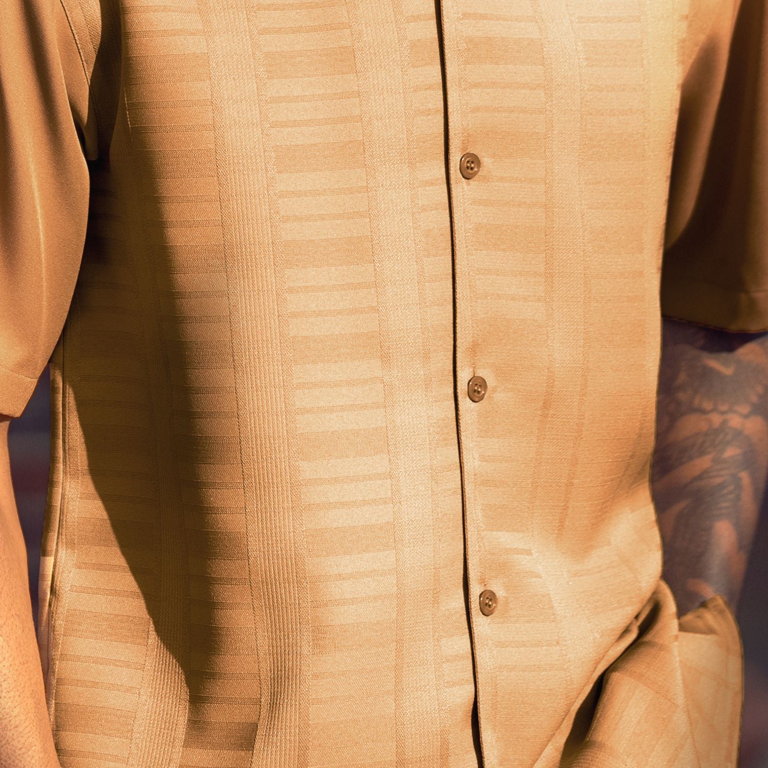 Close-up of camel men's walking suit shirt showing the subtle tone-on-tone textured weave pattern.