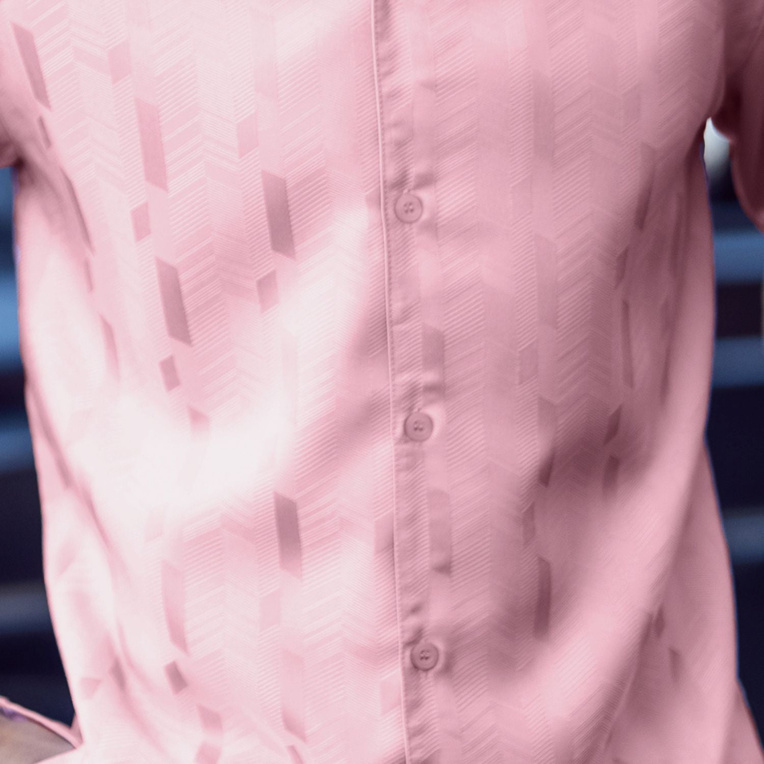 Close-up of pink walking suit shirt showing the detailed tone-on-tone jacquard weave pattern.