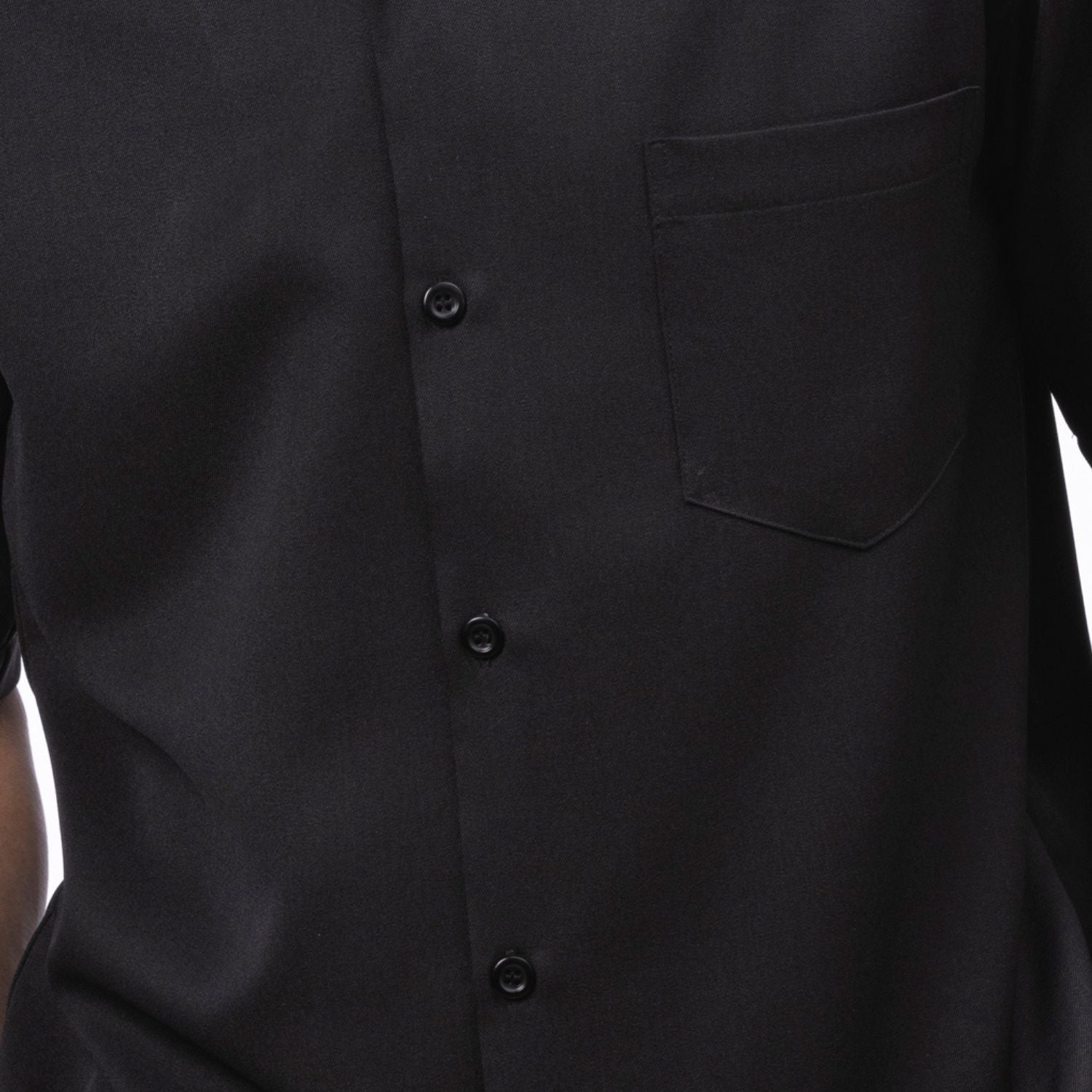 Close-up of black solid walking suit shirt showing the open collar and clean button-front design.