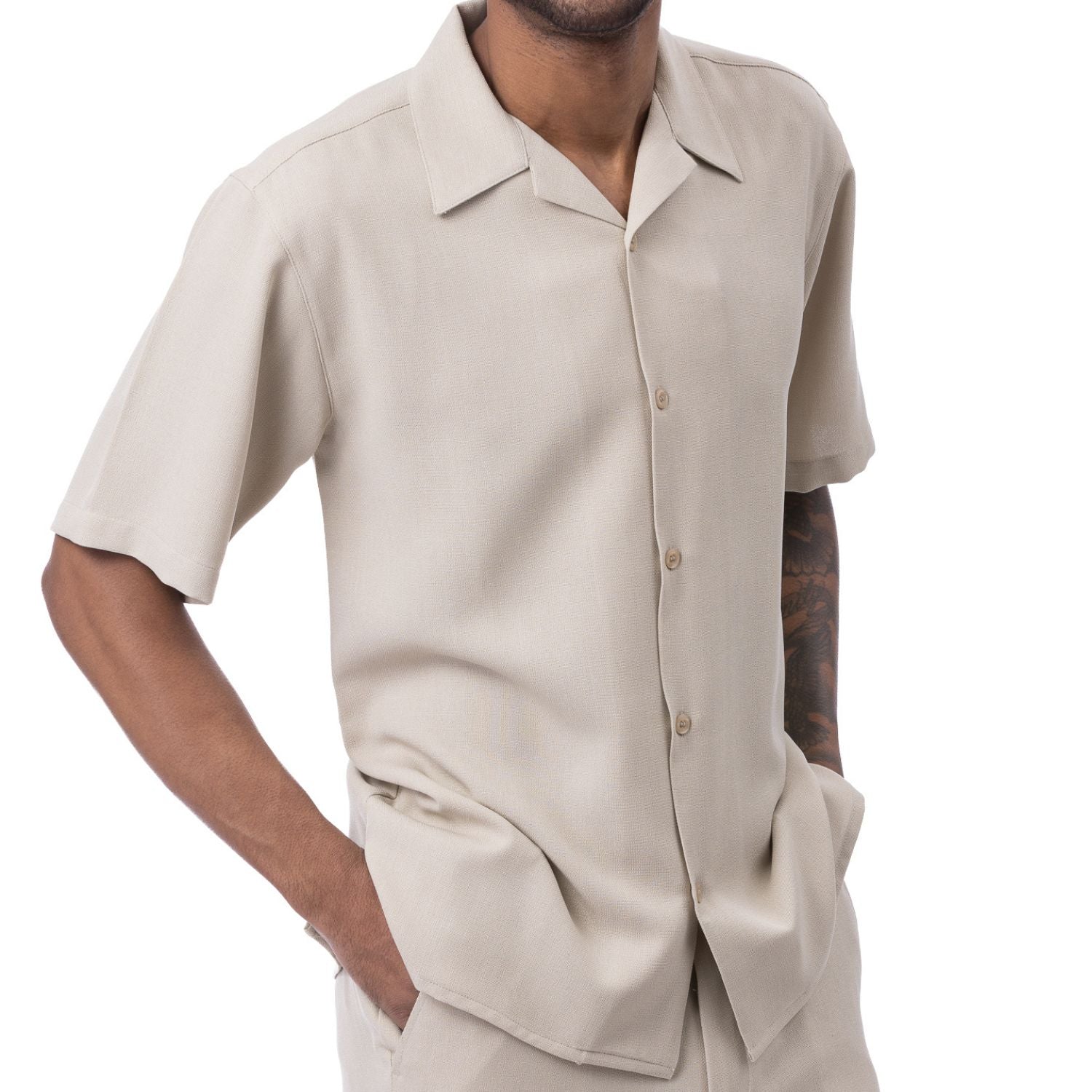Front view of the beige short sleeve walking suit shorts set on a model.