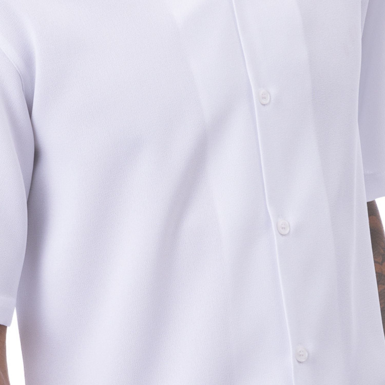 Close-up of white men's walking suit shirt showing the detailed linen-look texture and open collar.