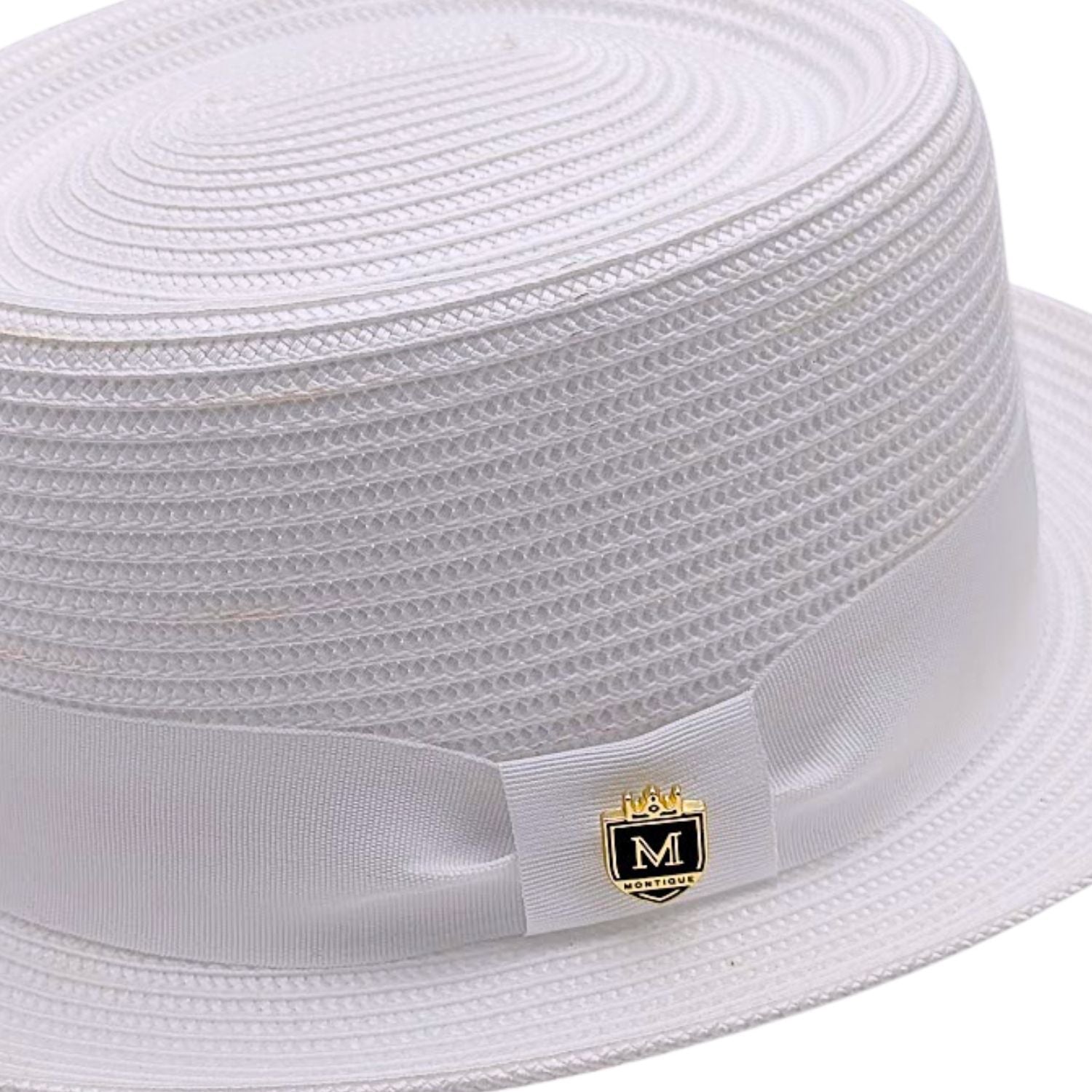 Close up of white Montique pork pie hat showing woven straw texture, matching band, bow detail, and logo pin