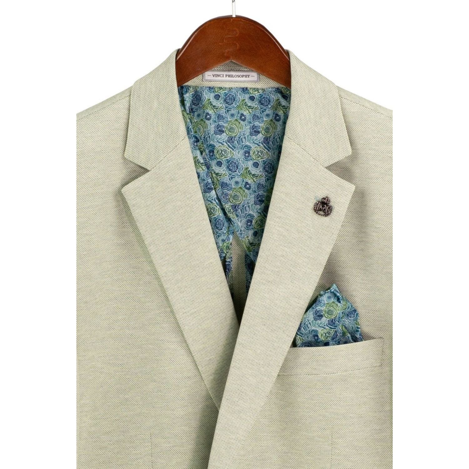 Close-up detail of light green textured weave blazer fabric and interior lining
