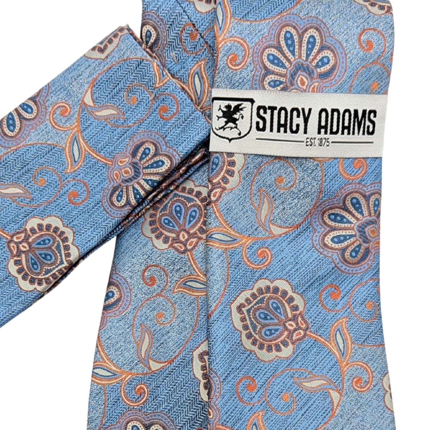 Close-up of the textured herringbone weave and orange floral pattern from the Stacy Adams Vandalia Collection.