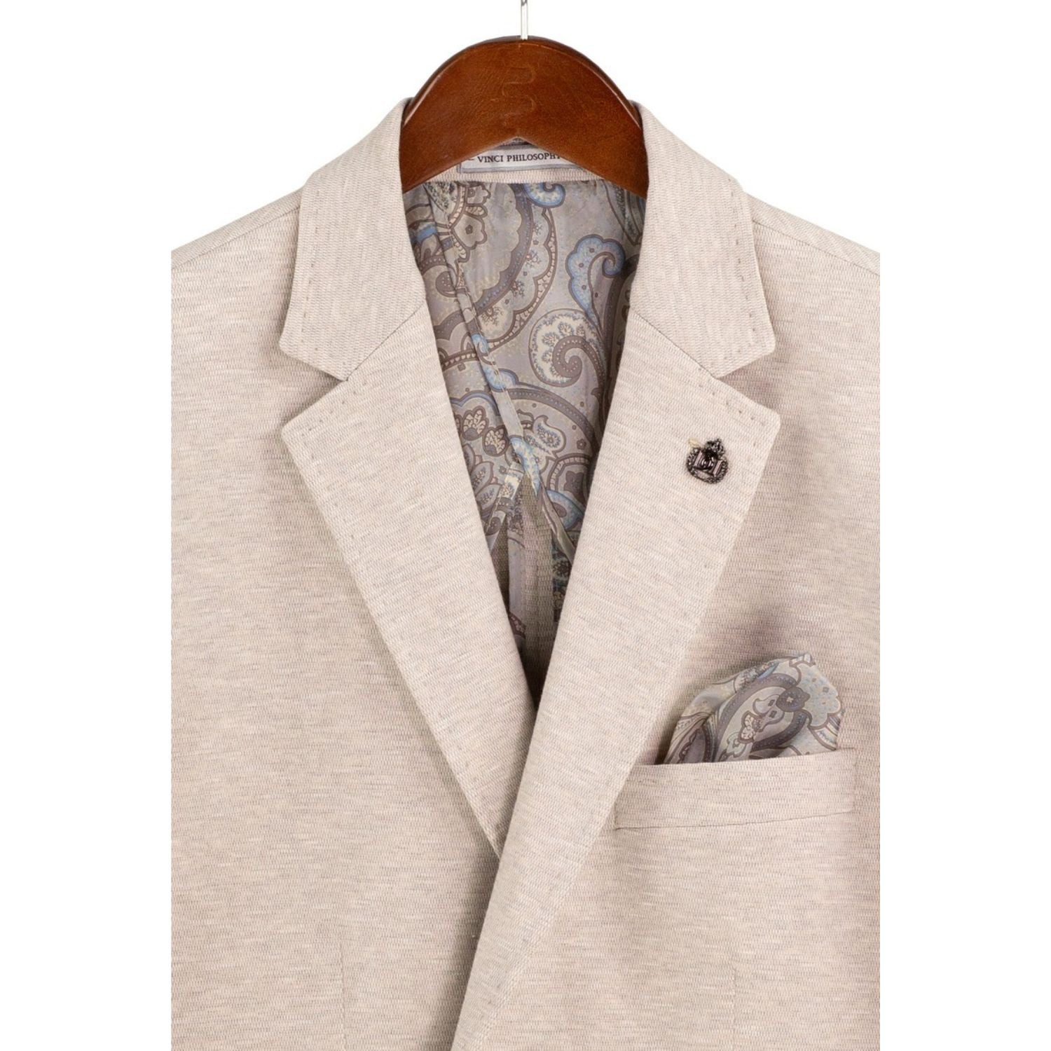 Close-up detail of oatmeal textured weave blazer fabric and lapel stitching