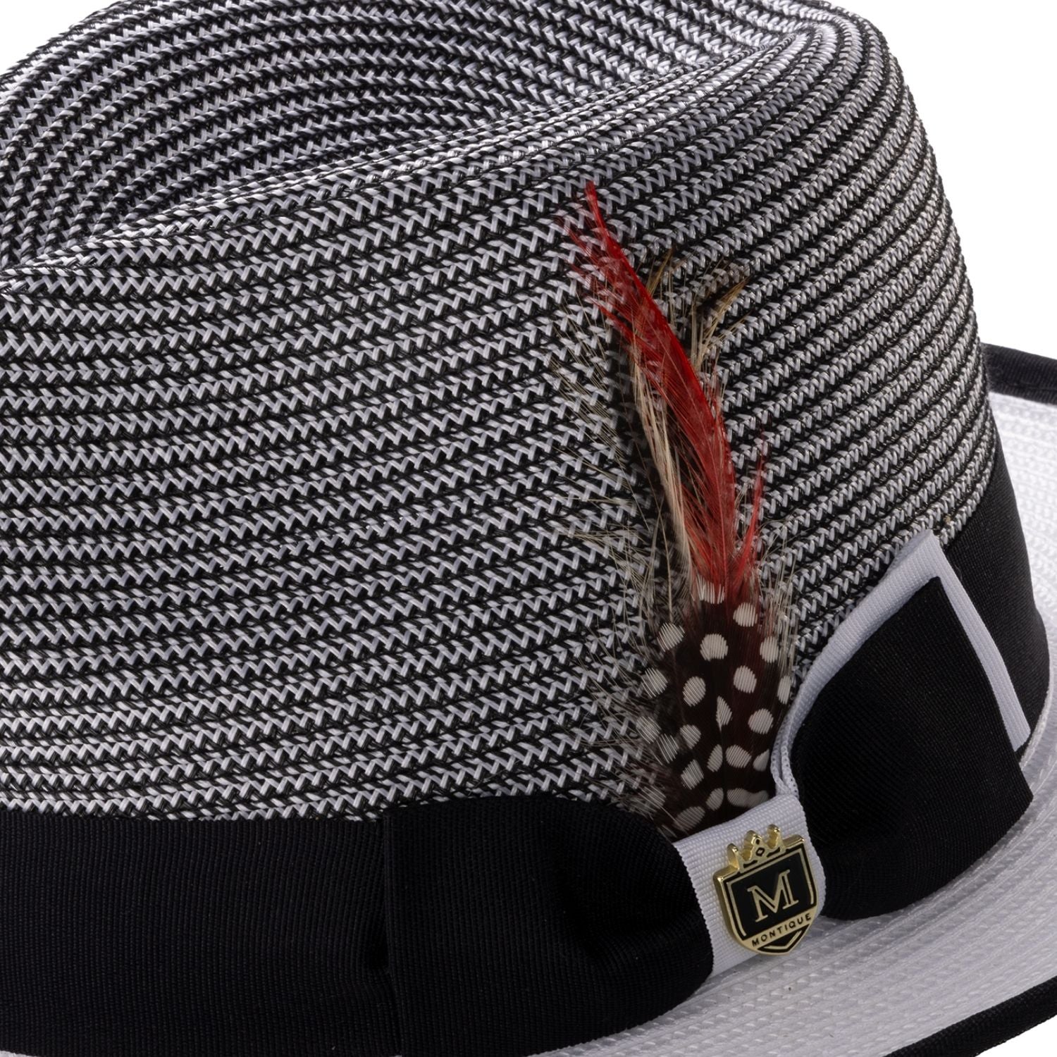 Side view of black and white Montique fedora hat with ribbon and feather