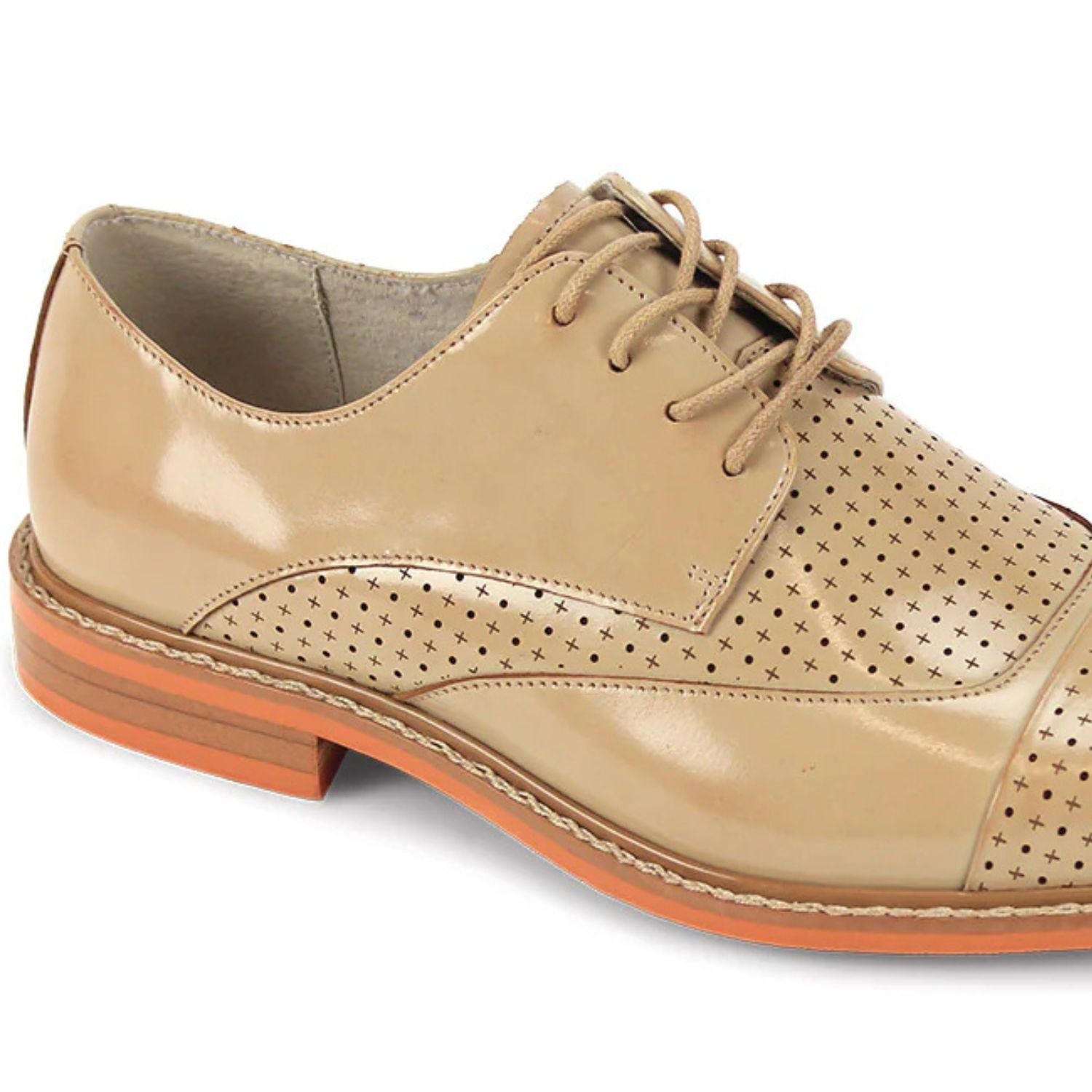 Close-up of tan leather cap-toe and intricate laser-cut perforated pattern.