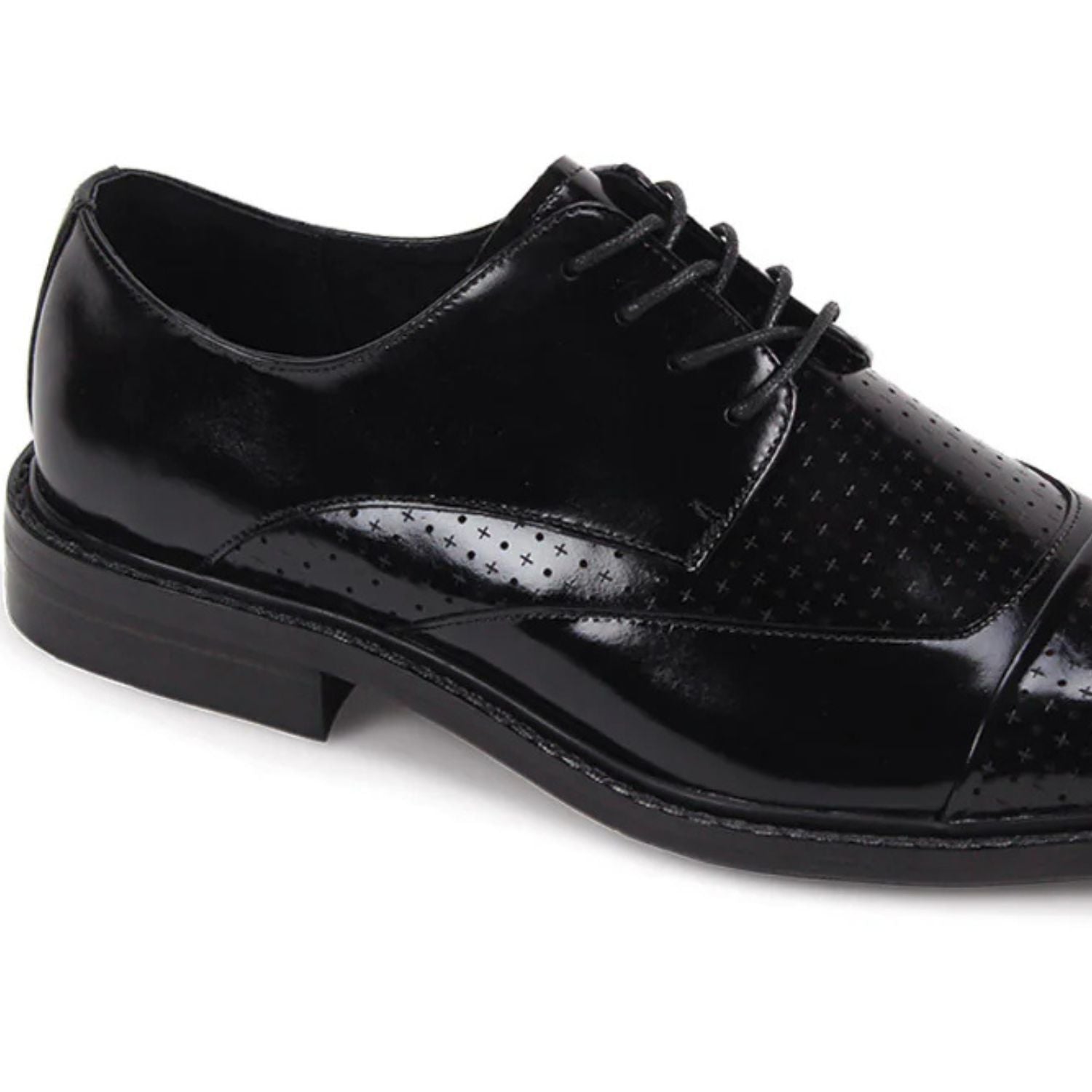 Close-up of black leather cap-toe and intricate laser-cut perforated pattern.