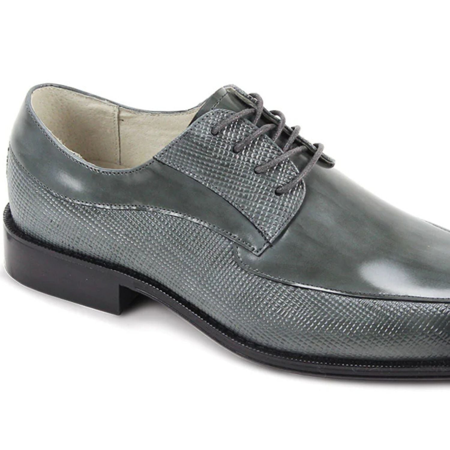Close-up of gray embossed leather texture and moc toe stitching detai