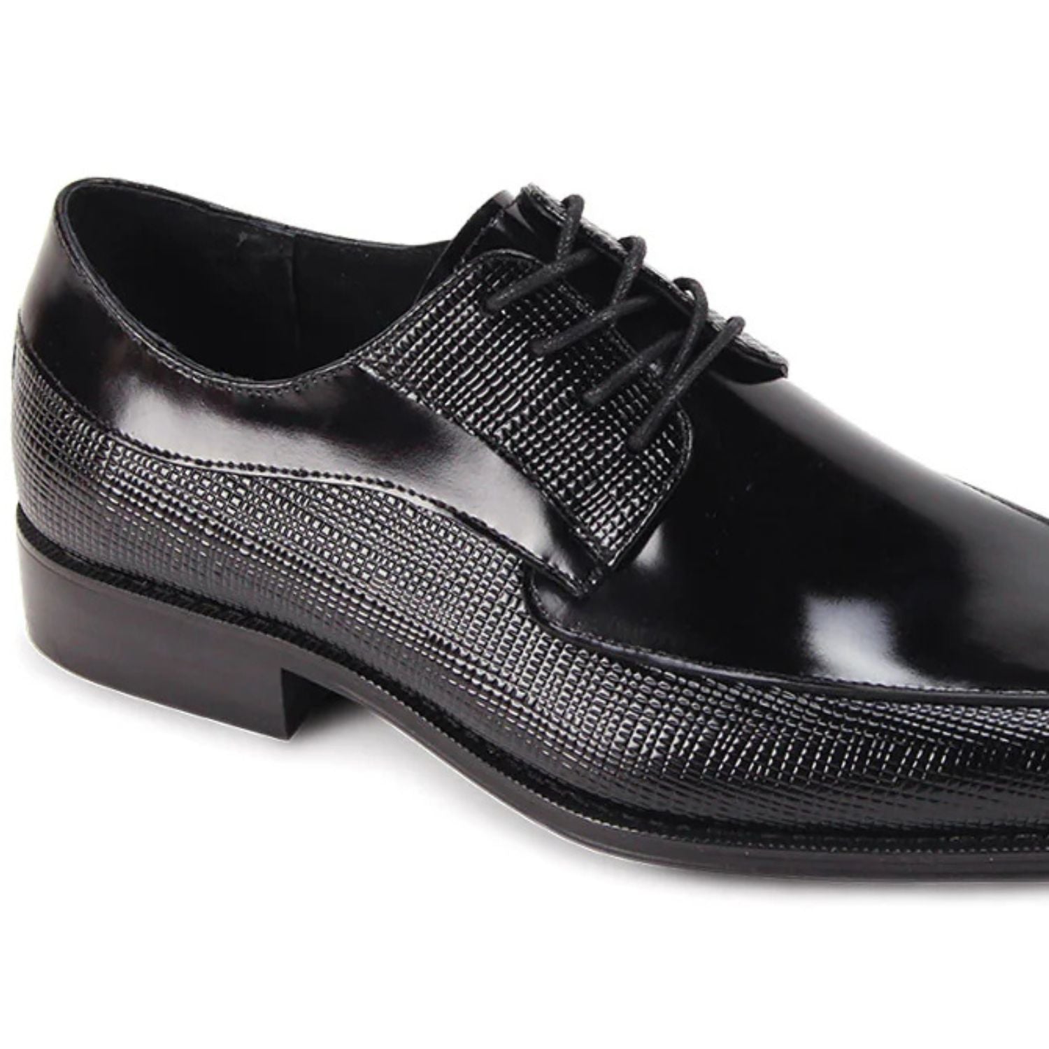 Close-up of black embossed leather texture and moc toe stitching detail.