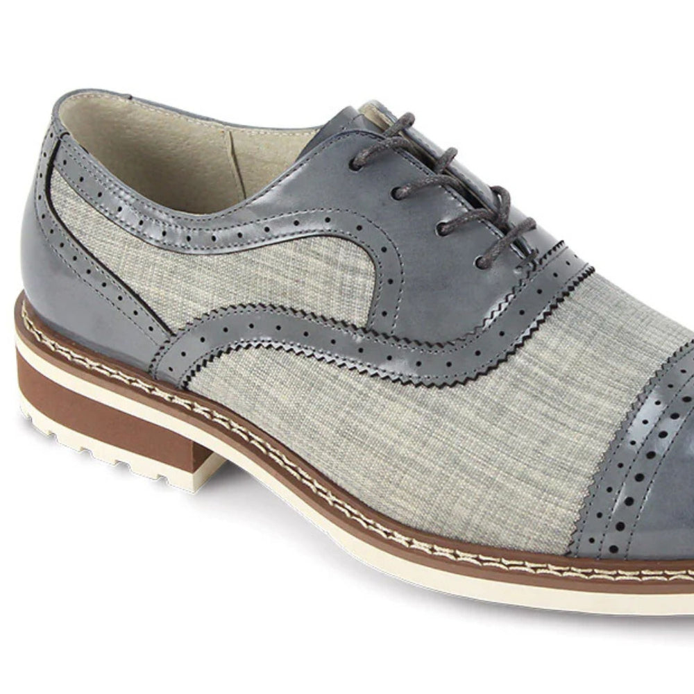 Close-up of grey leather brogue stitching and textured salt-and-pepper tweed fabric.