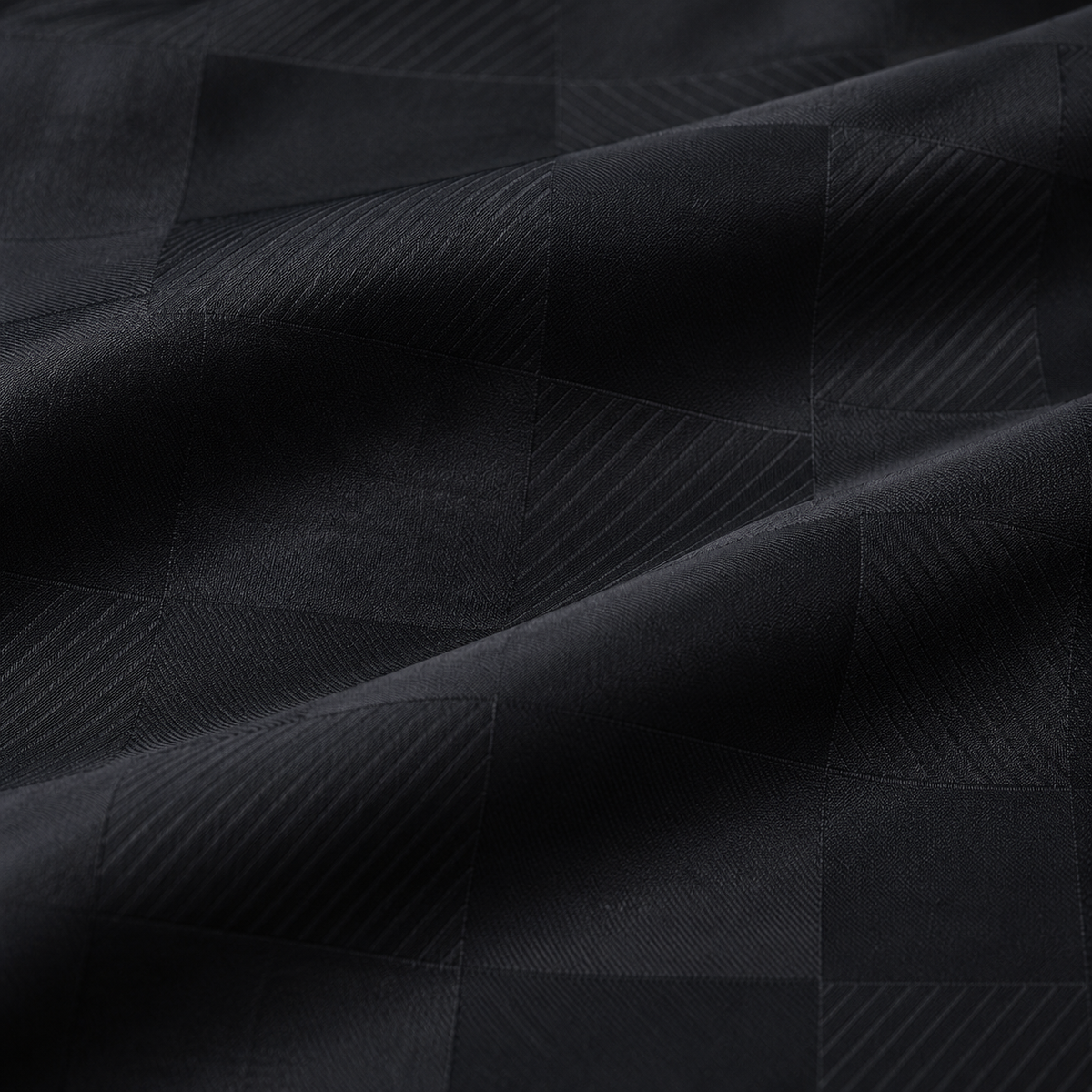 Close-up of the fine black tonal rectangular fabric in a Montique walking suit shirt.