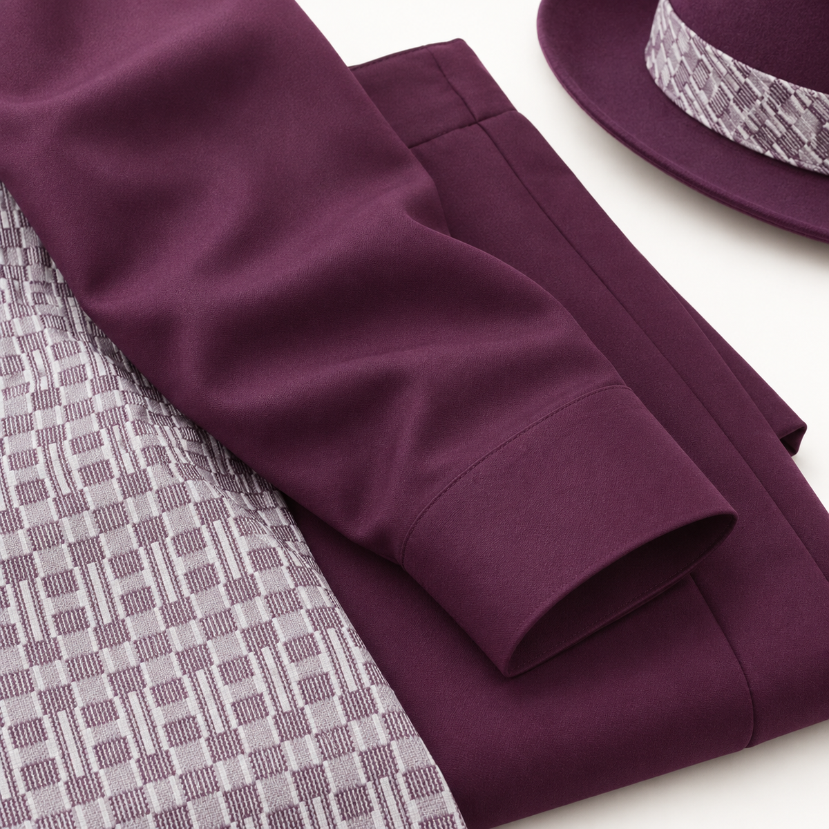 Montique plum walking suit sleeve and matching trouser fabric beside the coordinating hat