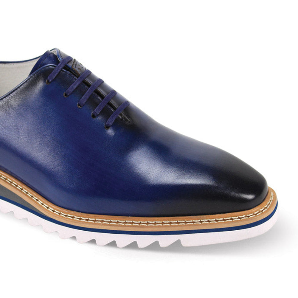 close up of blue plain toe lace-up leather dress shoes