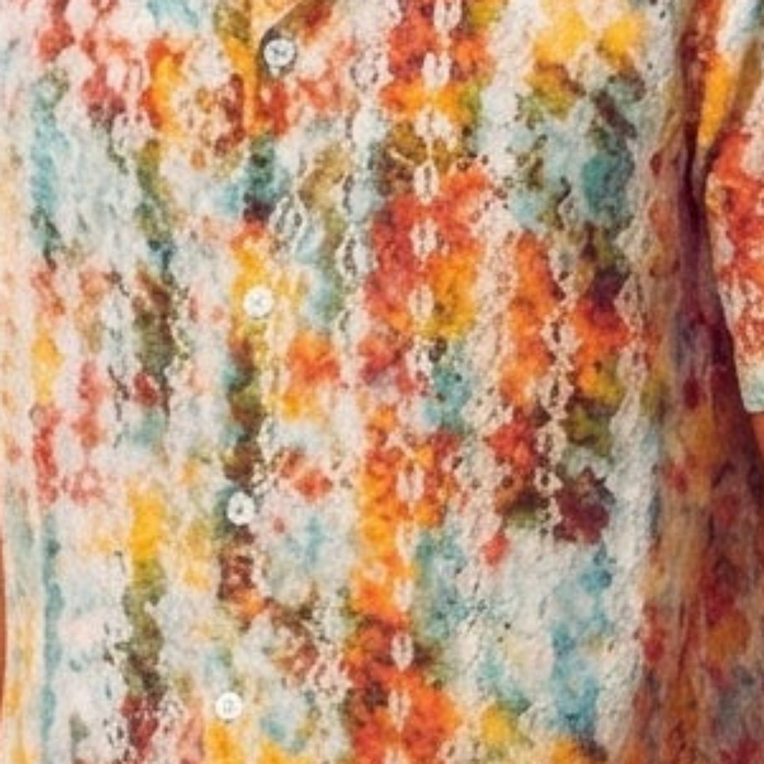 Close-up of the white shirt showing the abstract print and textured linen blend fabric.