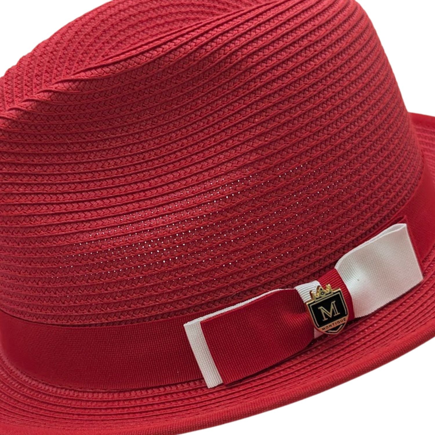 red straw fedora hat close up with red and white bow band