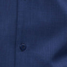 Close-up of navy 100% polyester fabric showing the solid texture and button detail