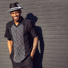 Black polyester men's walking suit short sleeve 2-piece set with geometric block panel puff design.