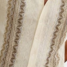Close-up of brown walking suit shirt showing the intricate vertical knit texture and button details.