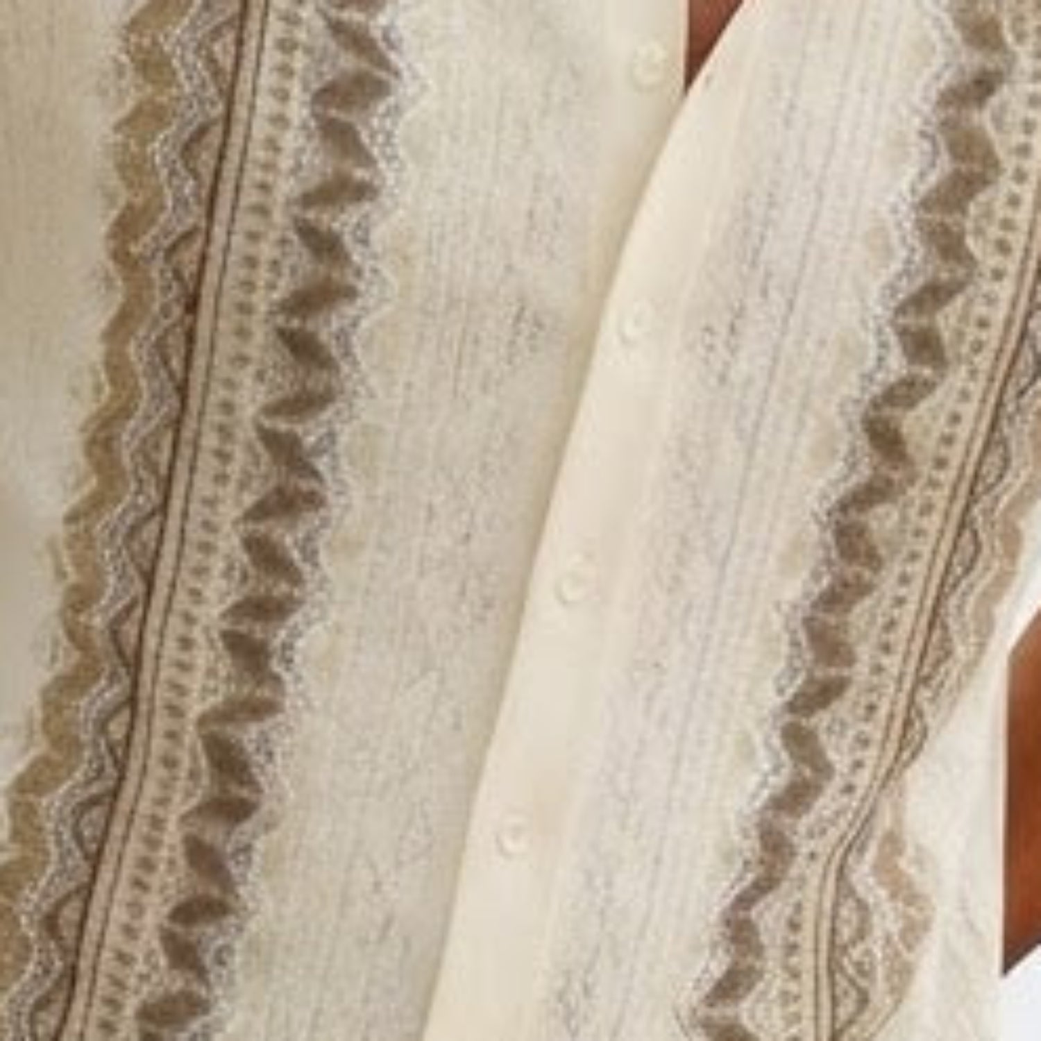 Close-up of brown walking suit shirt showing the intricate vertical knit texture and button details.