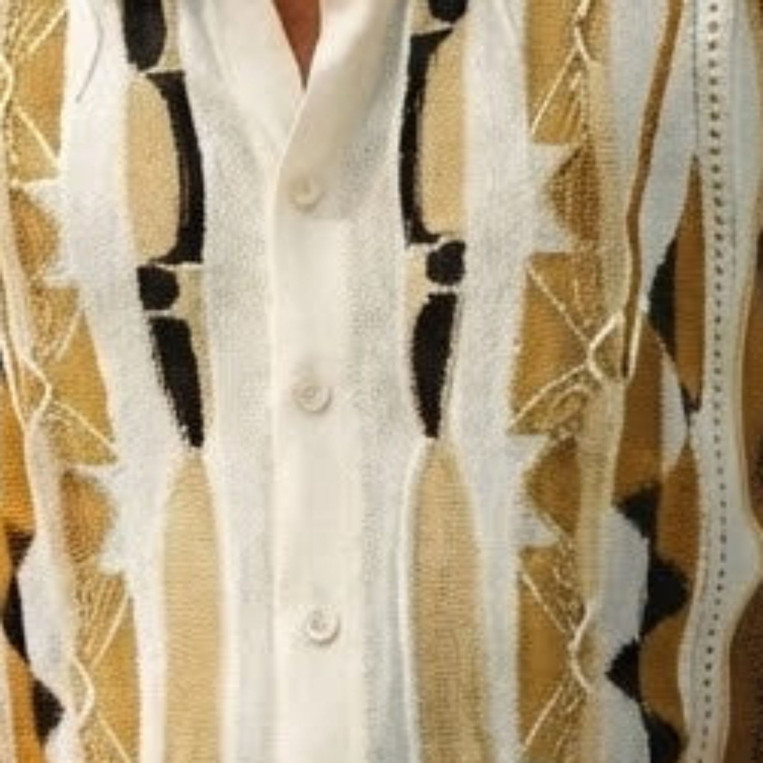 Close-up of walking suit shirt showing the tan geometric knit texture and button details