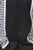 close up of black checker plaid color block walking suit shirt
