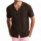 Men’s brown knitted short sleeve polo shirt with vertical openwork stripe design and button-front collar.