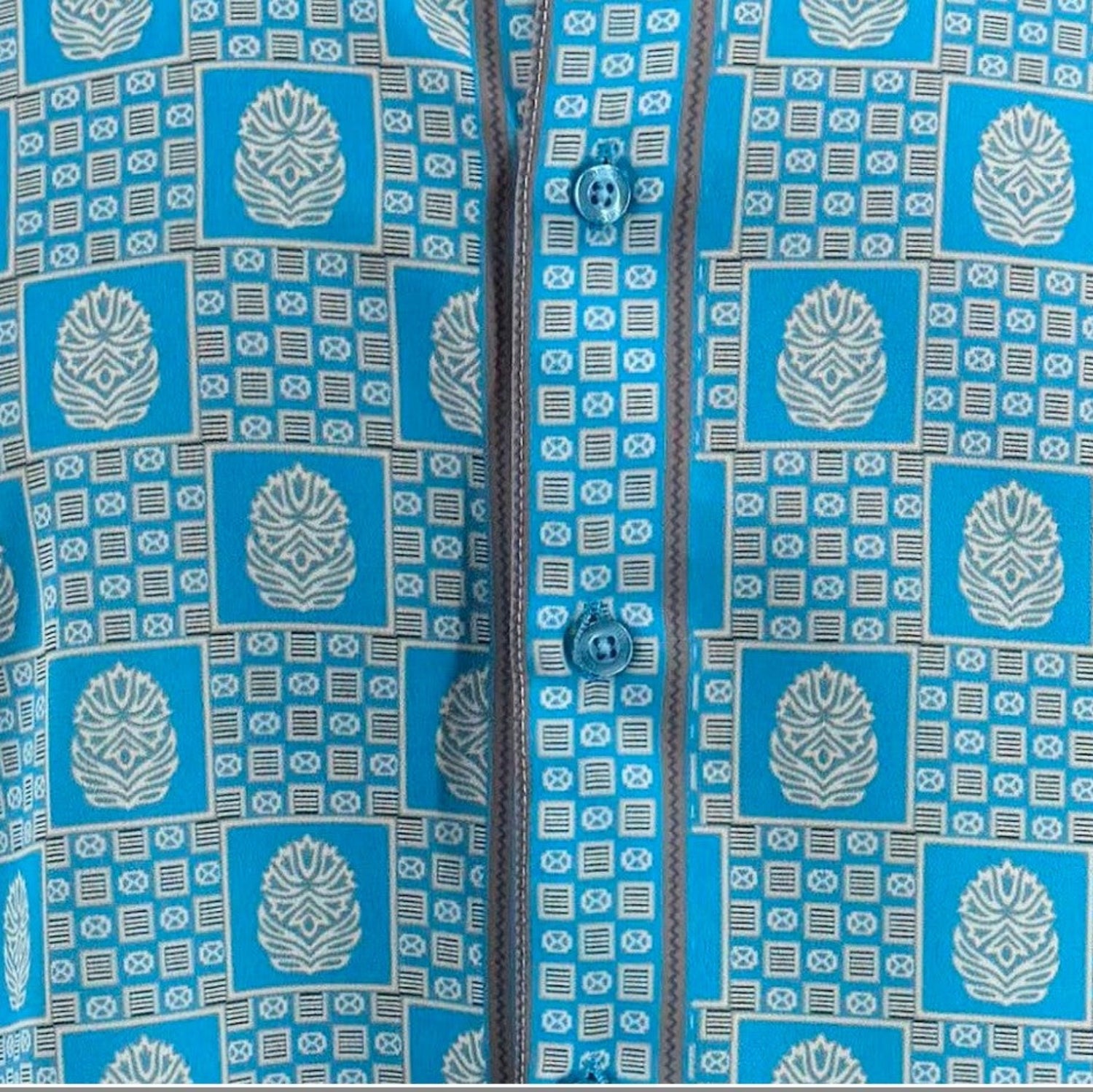 Close-up of Turquoise geometric tile and medallion shirt print