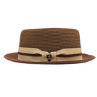 Cappuccino Montique pork pie straw hat side view with flat crown, beige ribbon band, burgundy cord detail, and gold logo pin