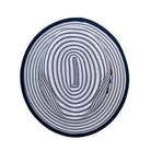 Navy and white Montique fedora top view showing striped woven crown, pinched crown shape, and navy brim edge