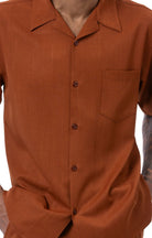 Close-up of cognac 100% polyester fabric showing the solid texture and button detail