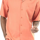 Close-up of coral 100% polyester fabric showing the solid texture and button detail