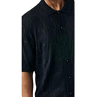 close up of black textured knit shirt ribbed stripe pattern