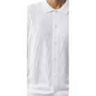 close up of white textured knit shirt ribbed stripe pattern