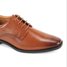 close-up of men’s cognac plain-toe lace-up dress shoe